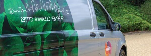 A close-up of a Mitie van, with 'Green Cleaner Cities' decal design on the side